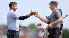 Two golfers shaking hands