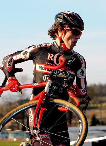 Josh Dillion (Richard Sachs-RGM Watches) lifting his bike over the barriers.