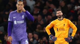 Virgil van Dijk and Alisson Becker look dejected after a mix-up costs Liverpool a goal against Arsenal in the Premier League in February 2024.