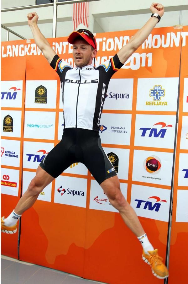 Stage 4 winner and race leader Karl Platt (Team Bulls) jumps for joy on the podium