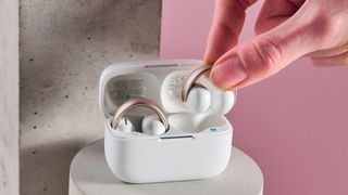 Someone picking a bud from the Anker Soundcore AeroClip charging case