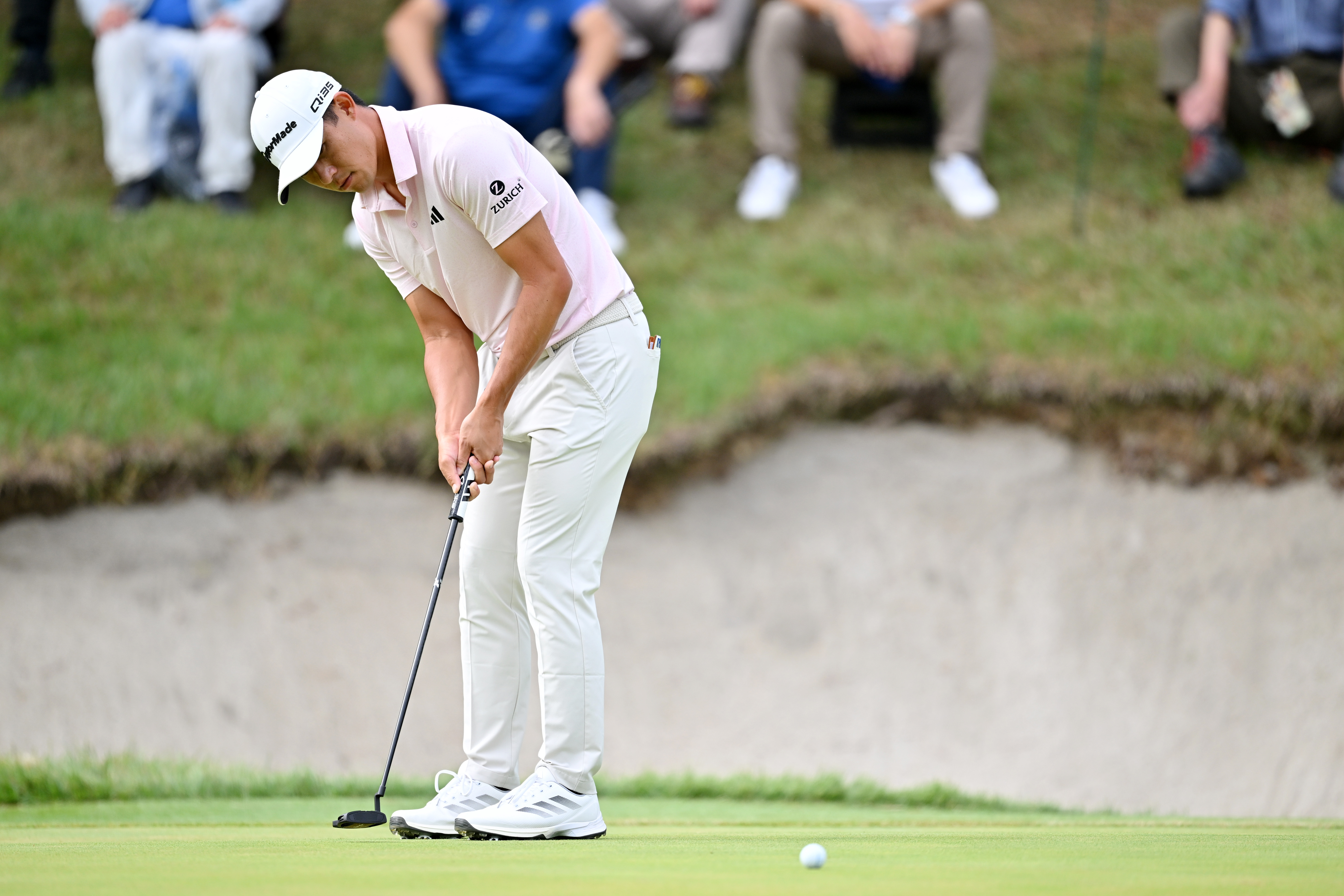 Collin Morikawa strikes a putt