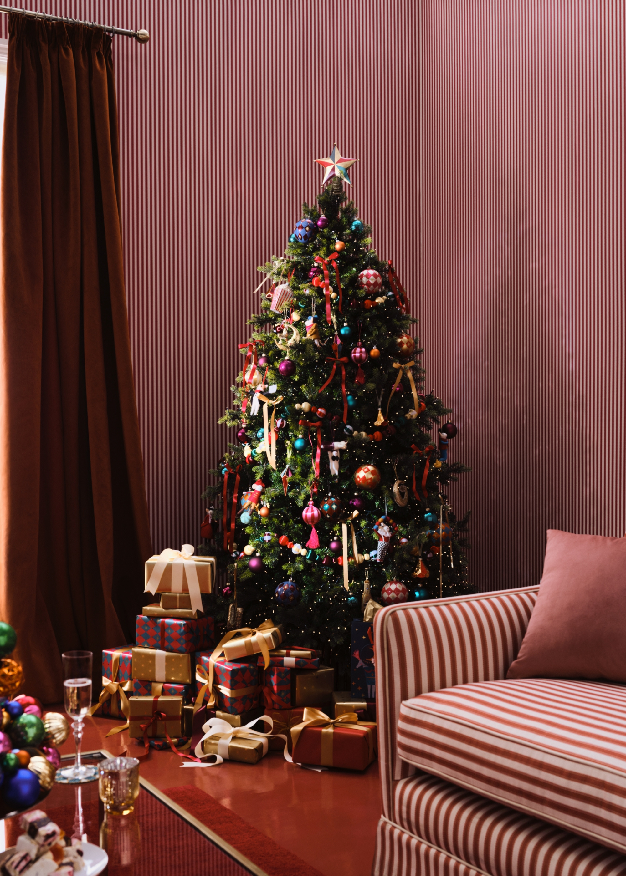 Candy striped room with colorful tree and lots of presents