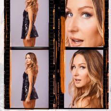 Nikki Glaser posing in a leather crocodile embossed mini dress.