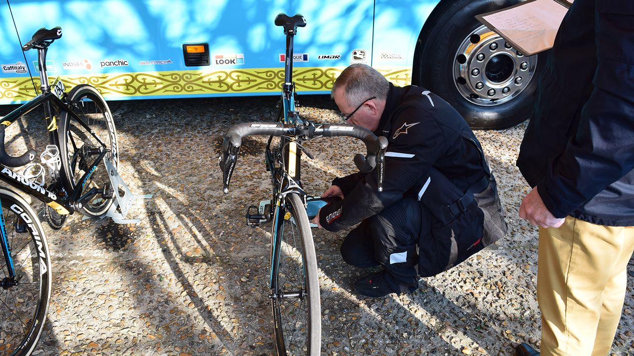 The UCI commissaires perform their checks for technological fraud ahead of the race start