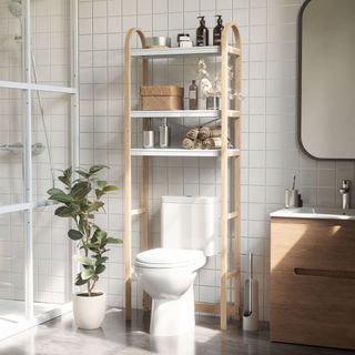 bathroom with white toilet, wooden shelving unit, white wall tiles and wooden cabinet drawer