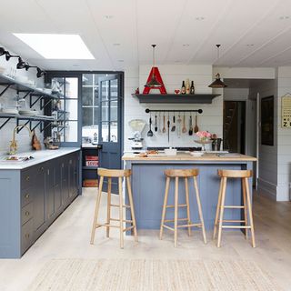 kitchen with dinner room with white wall