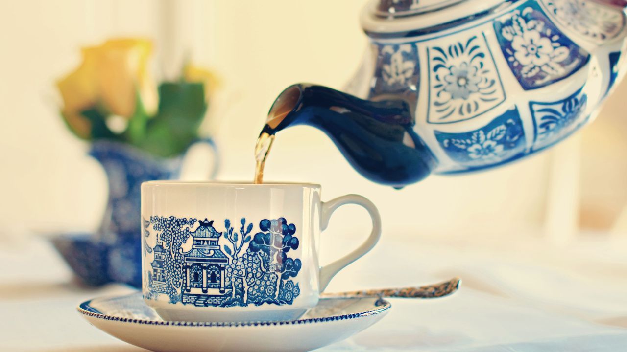 tea being poured from tea pot into cup