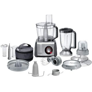 The Bosch MultiTalent 8 food mixer surrounded by a variety of mixing attachments, containers, and other accessories.