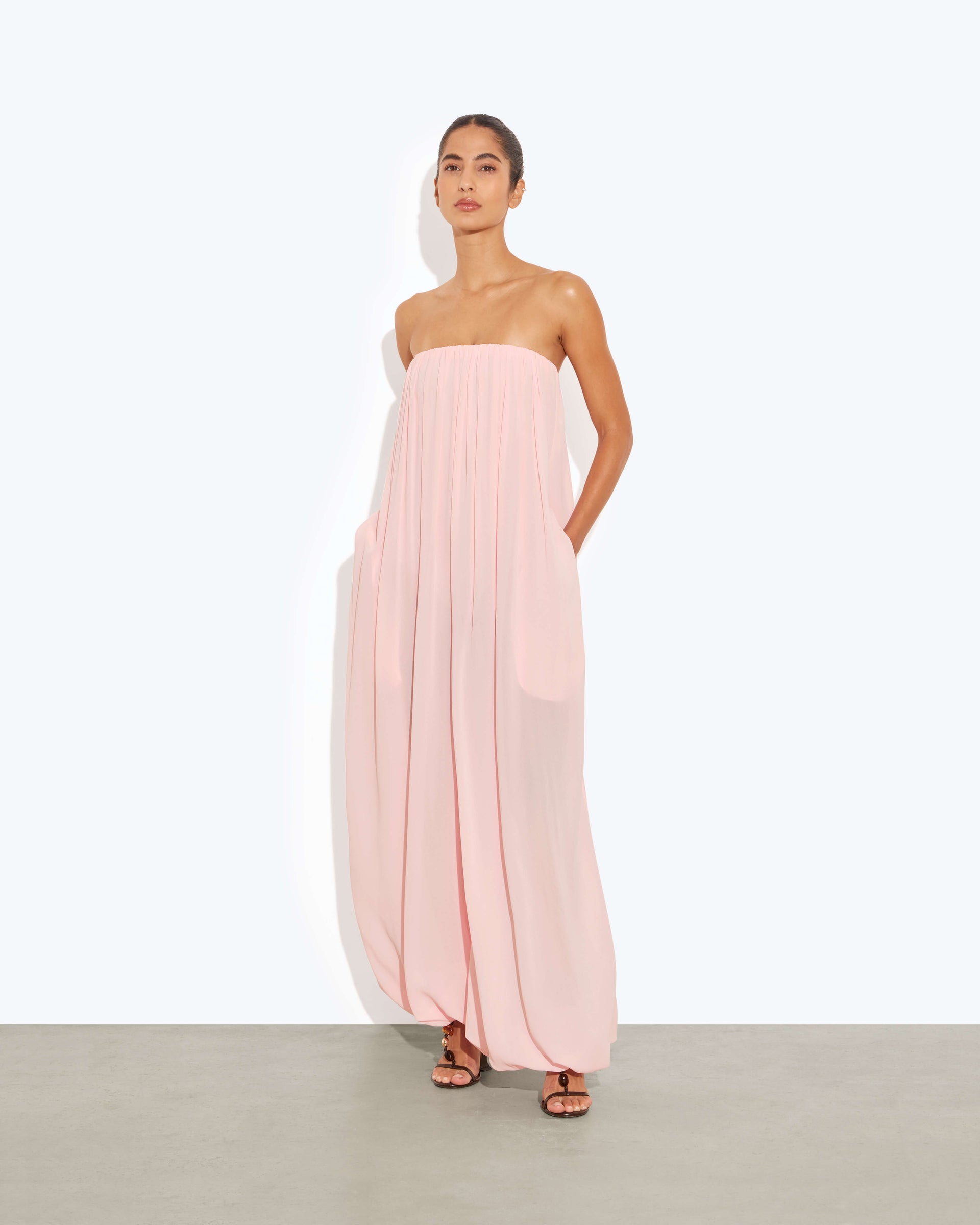 a model wearing a pink jumpsuit by rat &amp;amp; boa