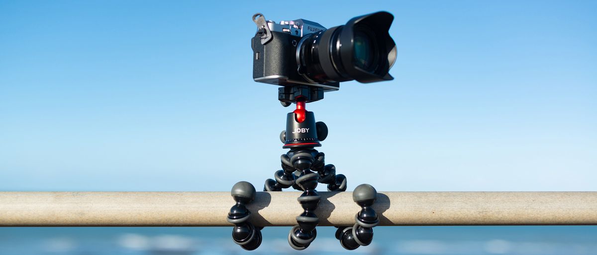 Joby gorillapod 5k tripod attached to a horizontal pole with a blue sky behind