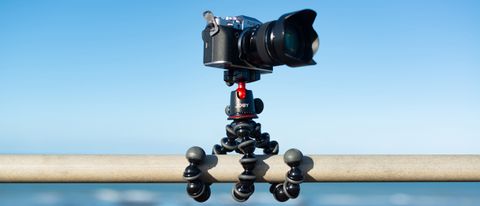 Joby gorillapod 5k tripod attached to a horizontal pole with a blue sky behind