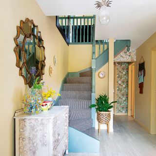 yellow hallway with blue staircase