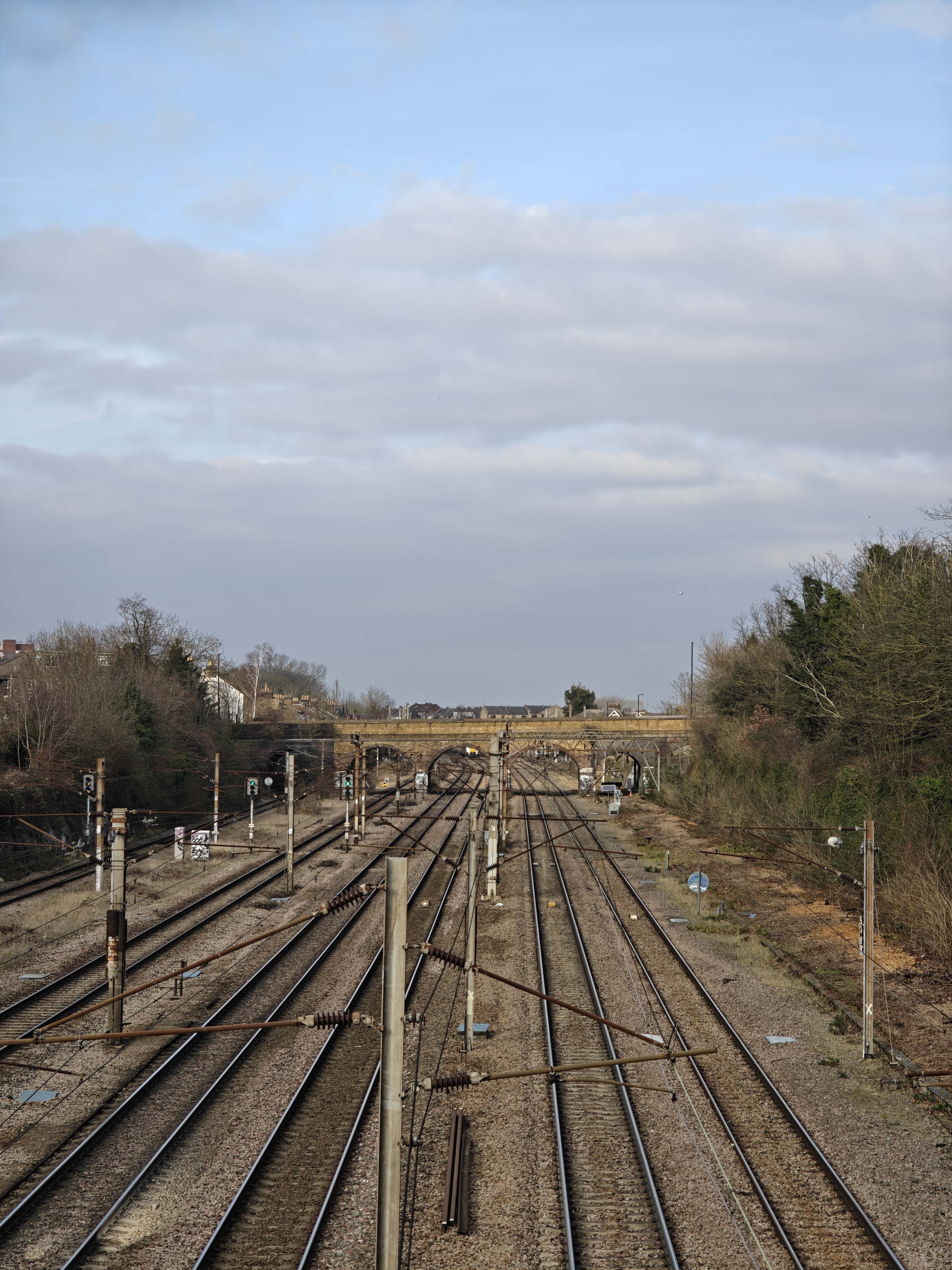 A railway track leading up to a stone bridge