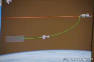 A graphic of Shenzhou 8's approach to the Tiangong 1 module on Nov. 2, 2011, Beijing time, to mark China's first space docking.