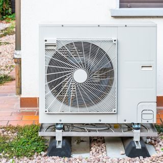 Exterior of house with installed heat pump