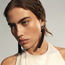 A model wears reformation earrings.