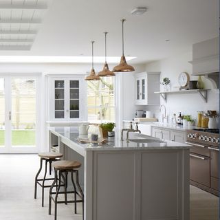 kitchen with white wall and kitchen counter with stool