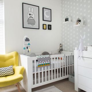 white nursery room with cradle and yellow chair