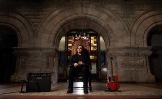 Tony Iommi seated in a church