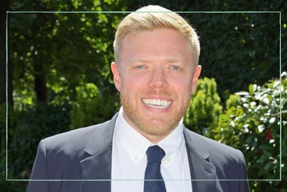Rob Beckett wearing a suit amiling
