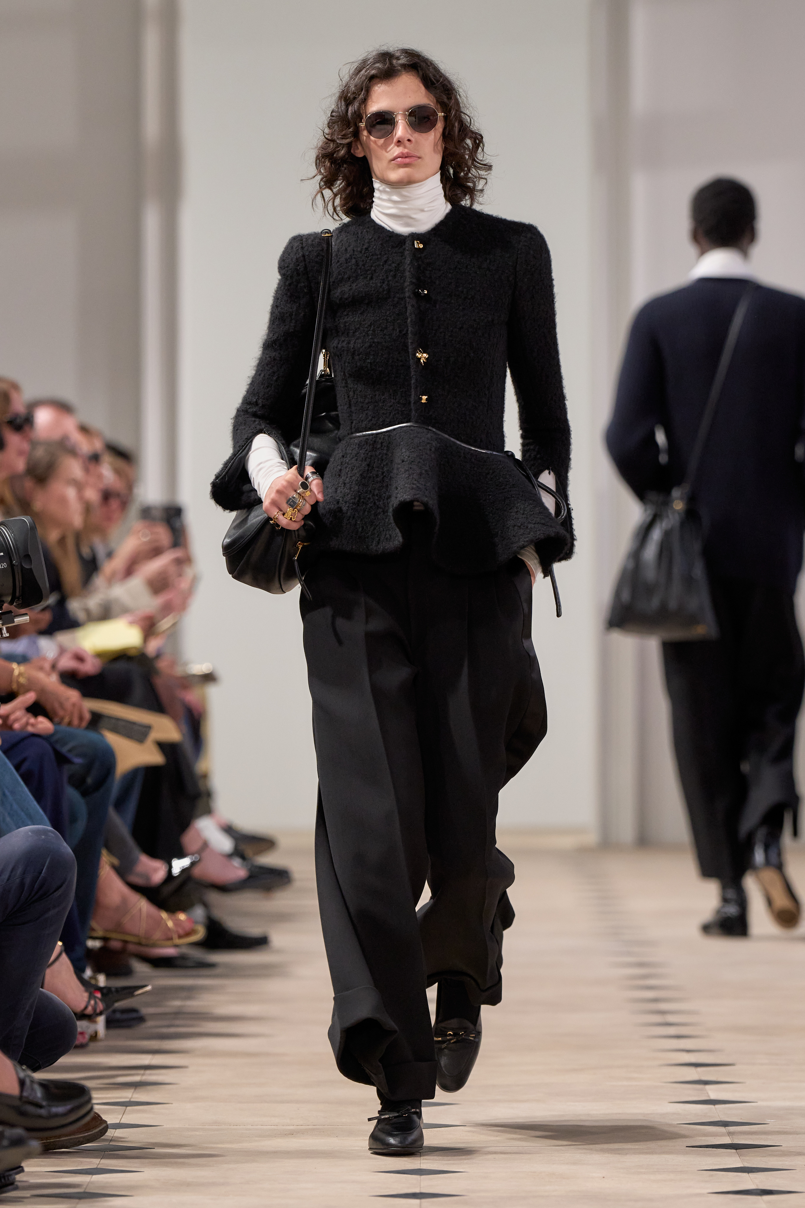 a model wears a turtleneck and peplum celine jacket