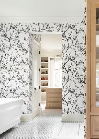 Farmhouse bathroom with black and white floral wallpaper and wooden units