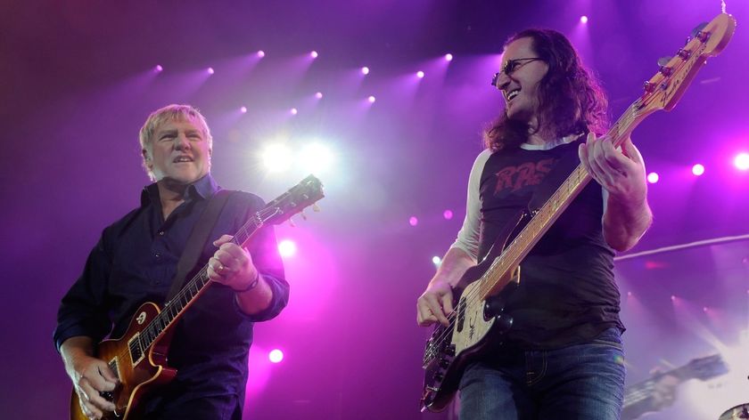  (L-R) Rush guitarist Alex Lifeson, singer/bassist Geddy Lee and drummer Neil Peart perform at the MGM Grand Garden Arena during a stop of the band's Time Machine Tour August 14, 2010 in Las Vegas, Nevada