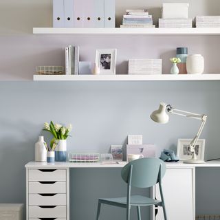 Pastel home office with white desk and floating shelves