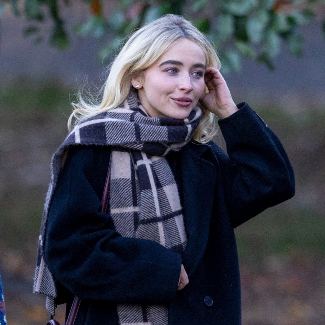 Sabrina Carpenter wearing a black Aritiza coat, plaid scarf, jeans, and a burgundy Celine bag in Central Park