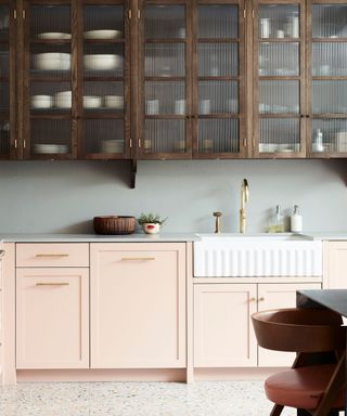 pink and wood toned kitchen area with fluted glass and butlers sink
