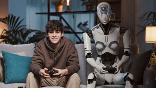 A teenage boy playing games on his couch with a humanoid android beside him.