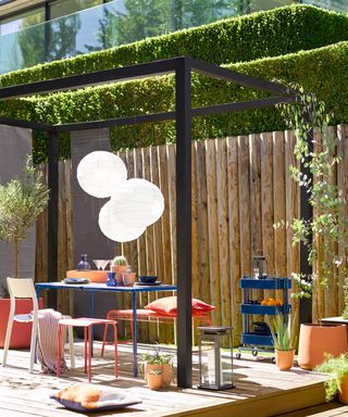 painted pergola with dining table