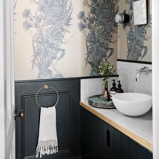 cloakroom with funky wallpaper on wall and wash basin