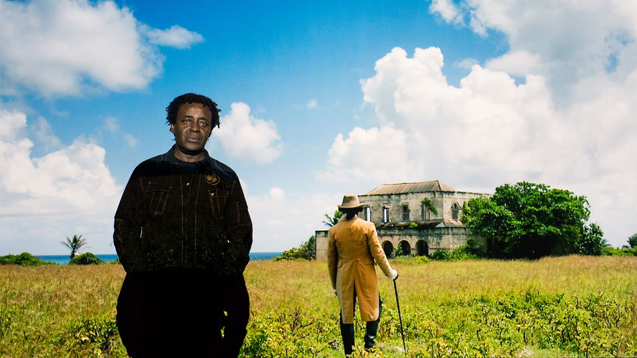 John Akomfrah with artwork Auto Da F&eacute;