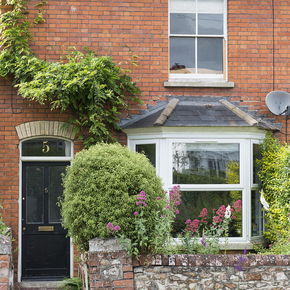 house with brick wall and and black door
