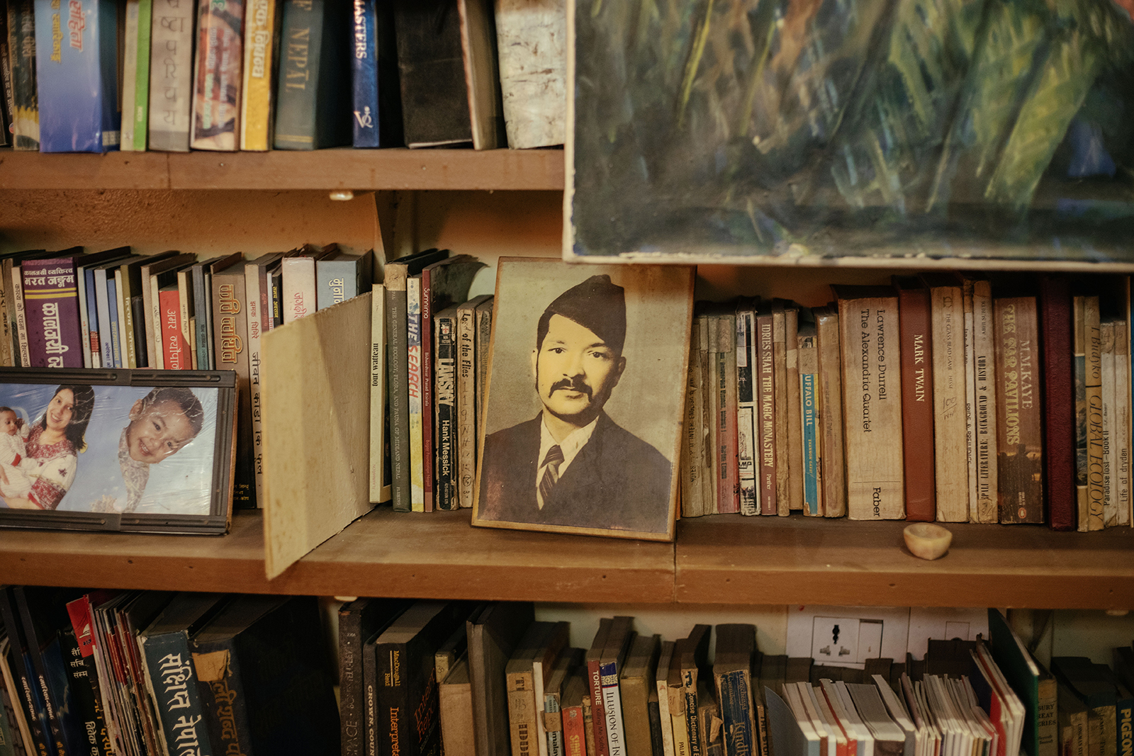 Manuj Babu Mishra&amp;rsquo;s studio, rich with full shelves, paintings, personal items and lots of colourful, lived-in decor