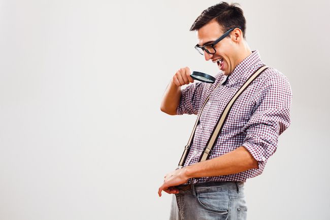 A man looking down his pants.