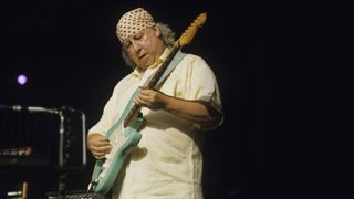 Peter green playing a Fender Strat onstage in 2001