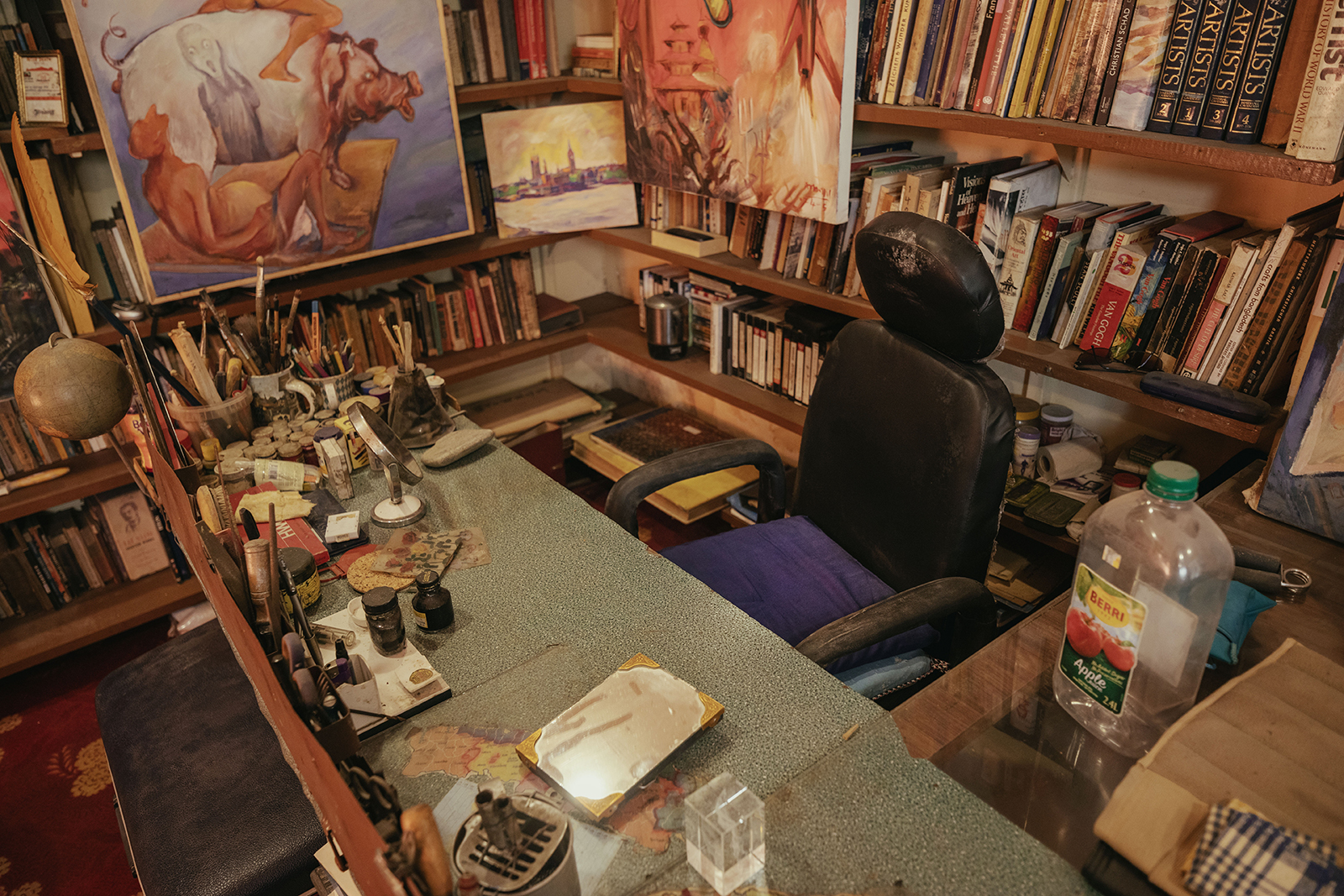 Manuj Babu Mishra&rsquo;s studio, rich with full shelves, paintings, personal items and lots of colourful, lived-in decor