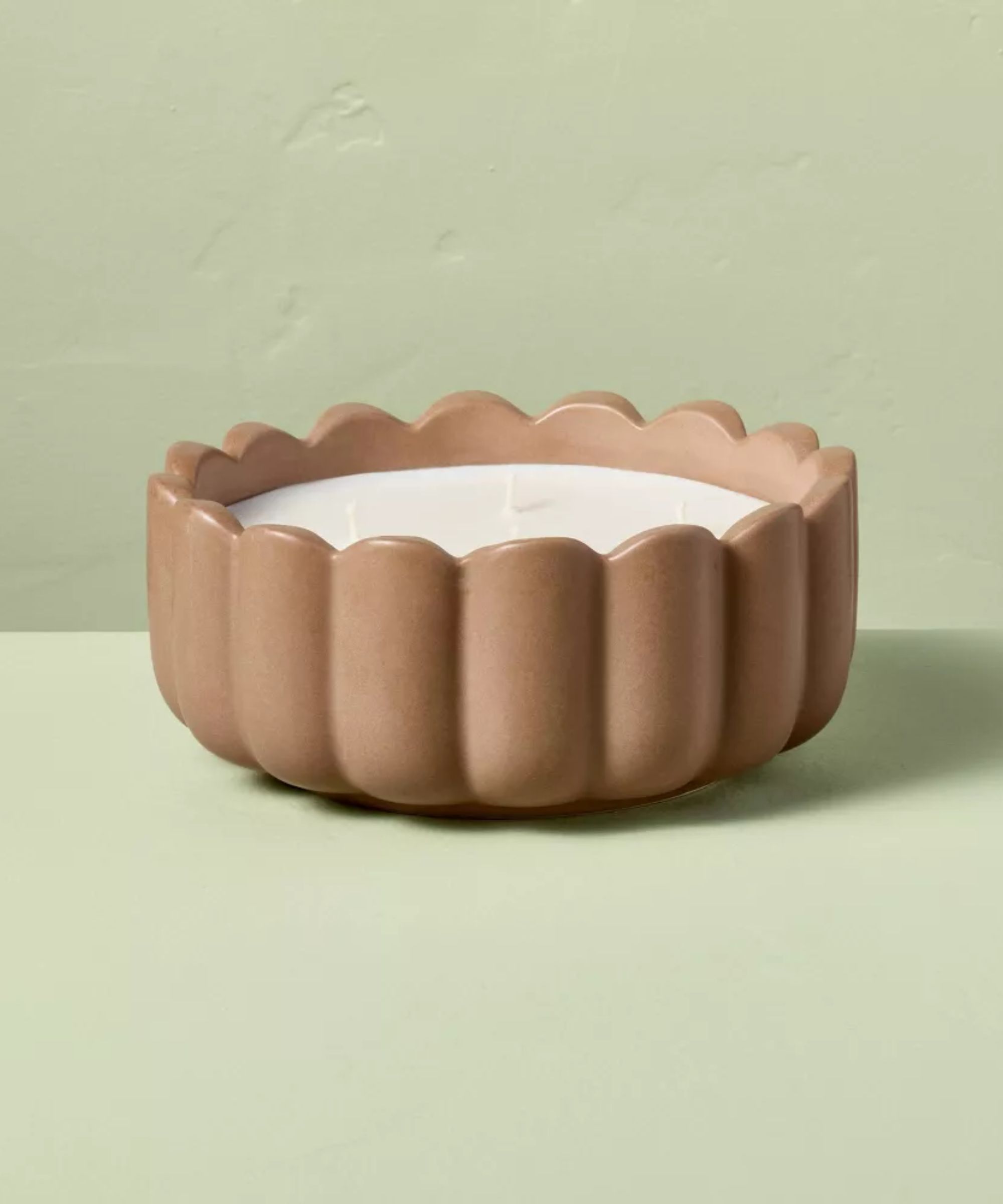 Scalloped taupe candle holder with white candle