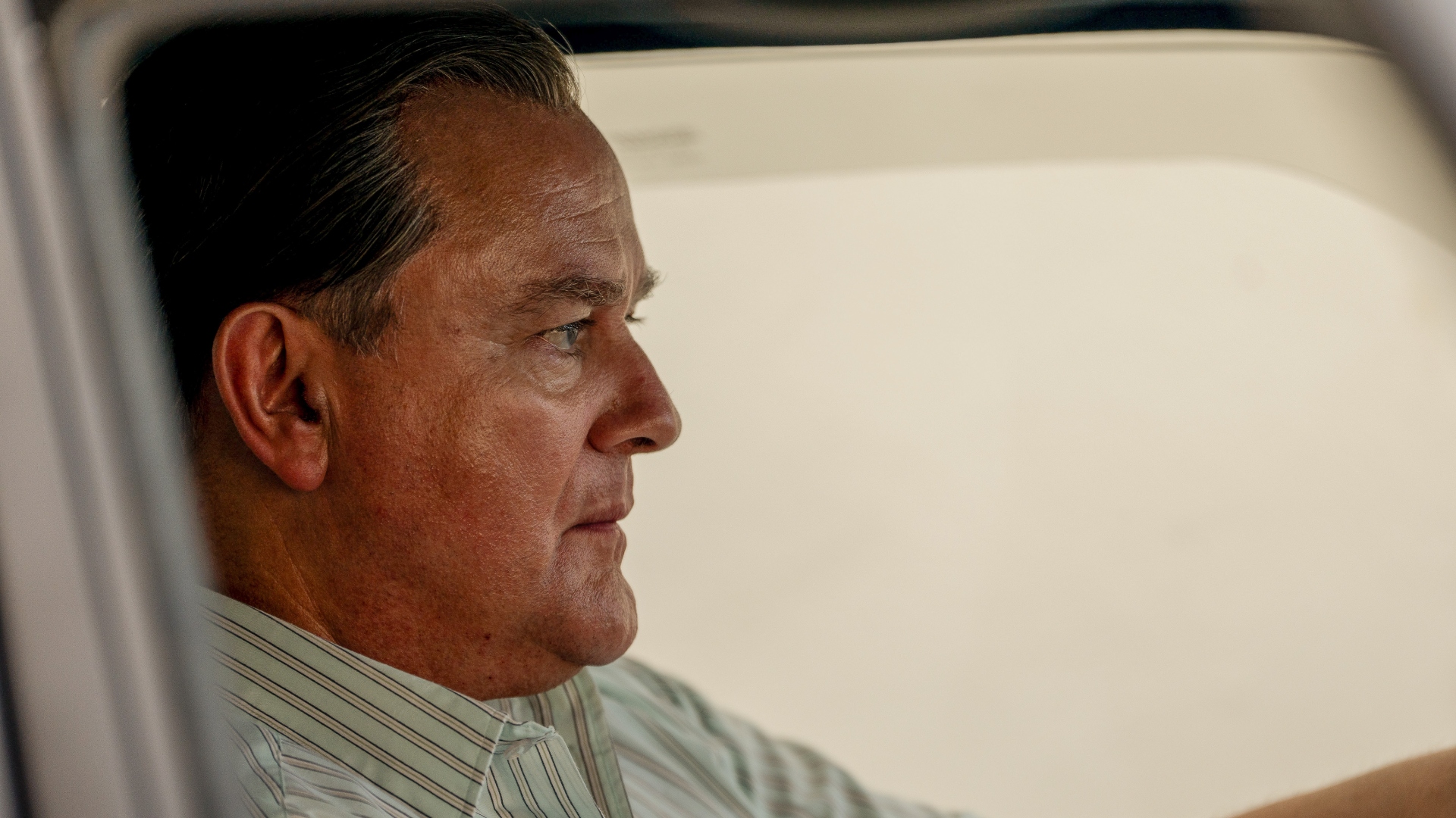 Boyce sits in his car in The Gold season 2