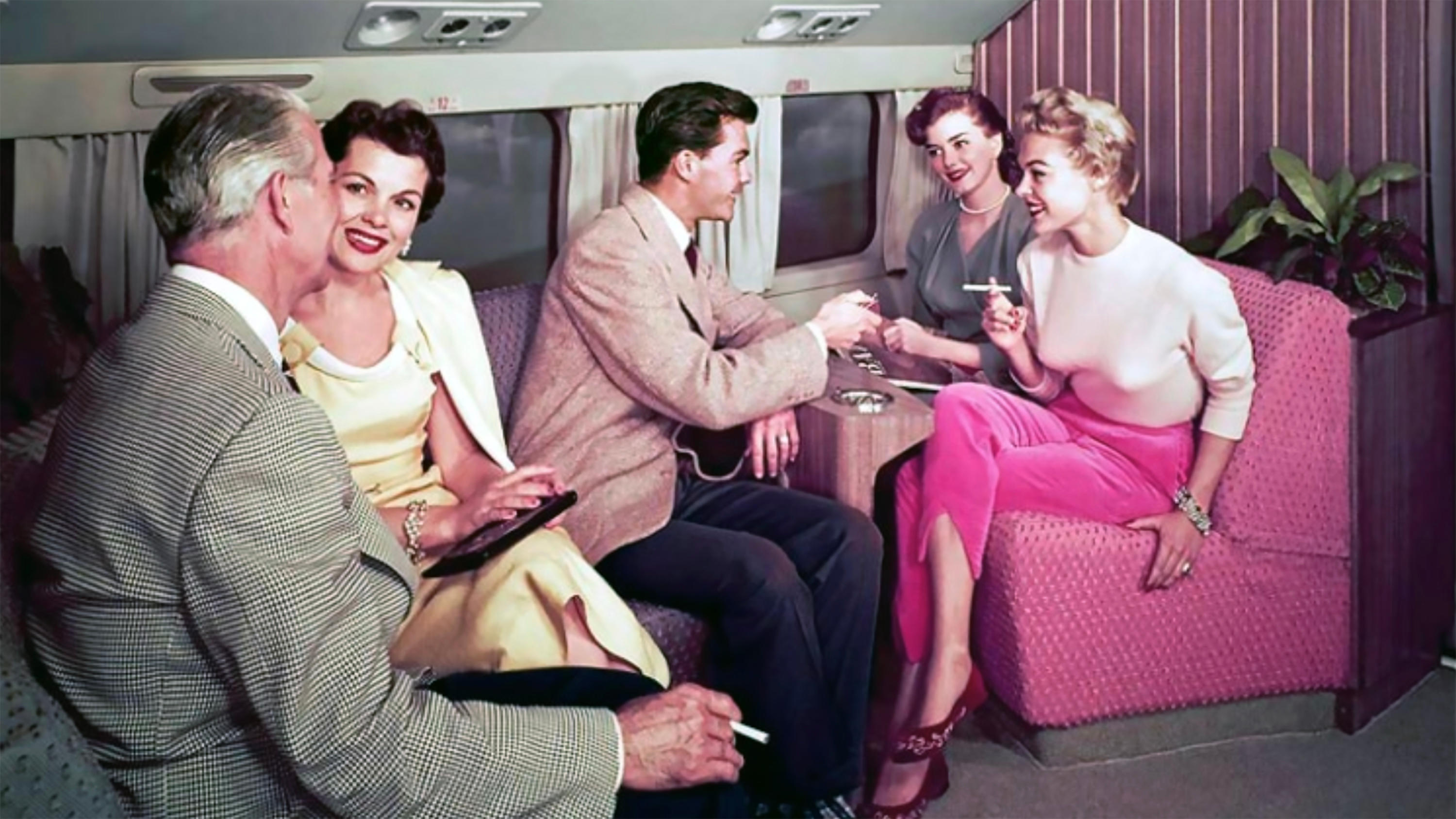 1950s image of five people travelling by airplane