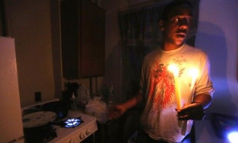 A Jacob Riis resident uses the stove for heat