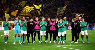 Newcastle United players acknowledge the fans following the team's defeat during the UEFA Champions League match between Borussia Dortmund and Newcastle United at Signal Iduna Park on November 07, 2023 in Dortmund, Germany.