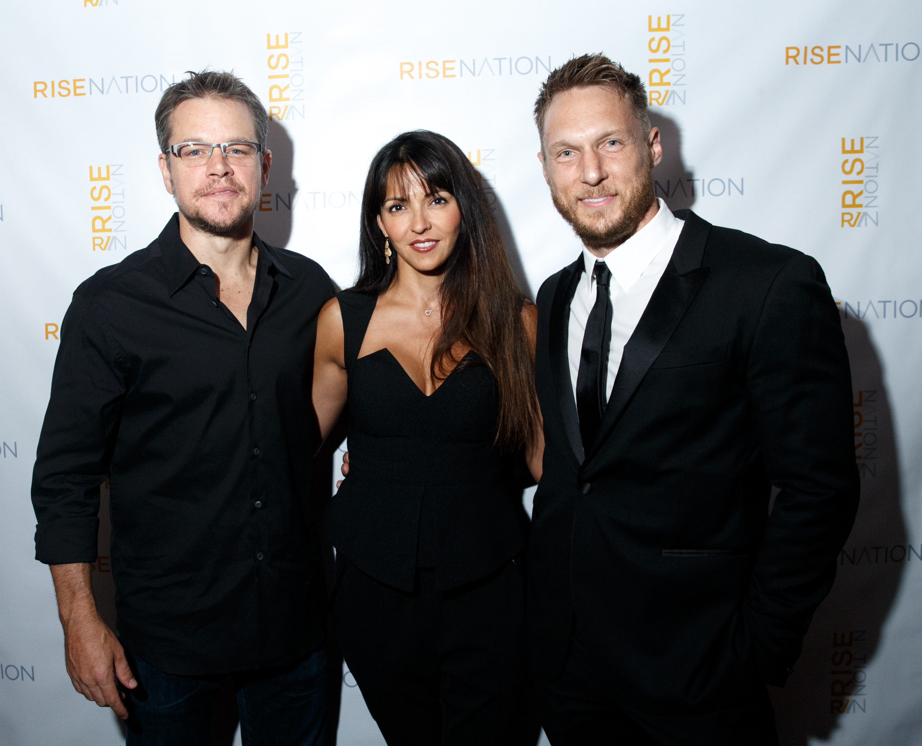 WEST HOLLYWOOD, CA - AUGUST 21: Actor Matt Damon, wife Luciana Damon and personal/celebrity trainer Jason Walsh attend 'Rise Nation Fitness Studio's Los Angeles Grand Opening' on August 21, 2015