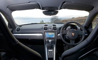 View from the back seat into the front, featuring black leather interior