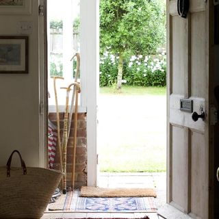 entrance hall with wooden door and jute bag