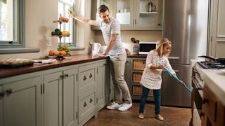Father and daughter use kitchen cleaning hacks