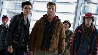 Katy O'Brian, Glen Powell, and Martin Herlihy as Laughlin, Ben Richards, and Jansky in The Running Man